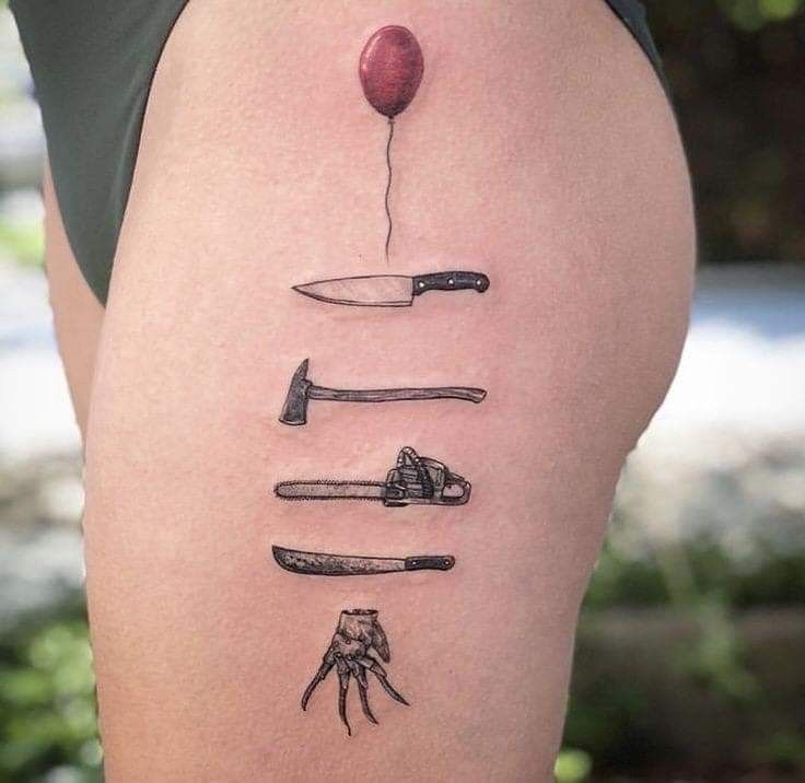 a woman's thigh with different knifes and an apple on it