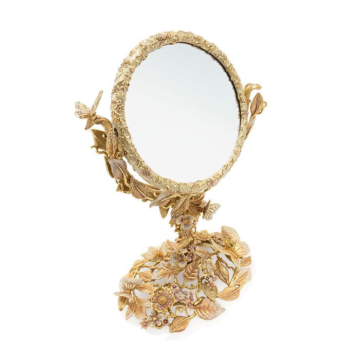 an ornately decorated mirror is shown against a white background with gold leaves and flowers