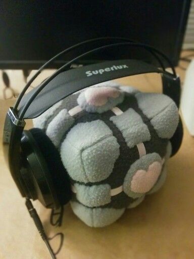 a stuffed animal with headphones on sitting in front of a computer