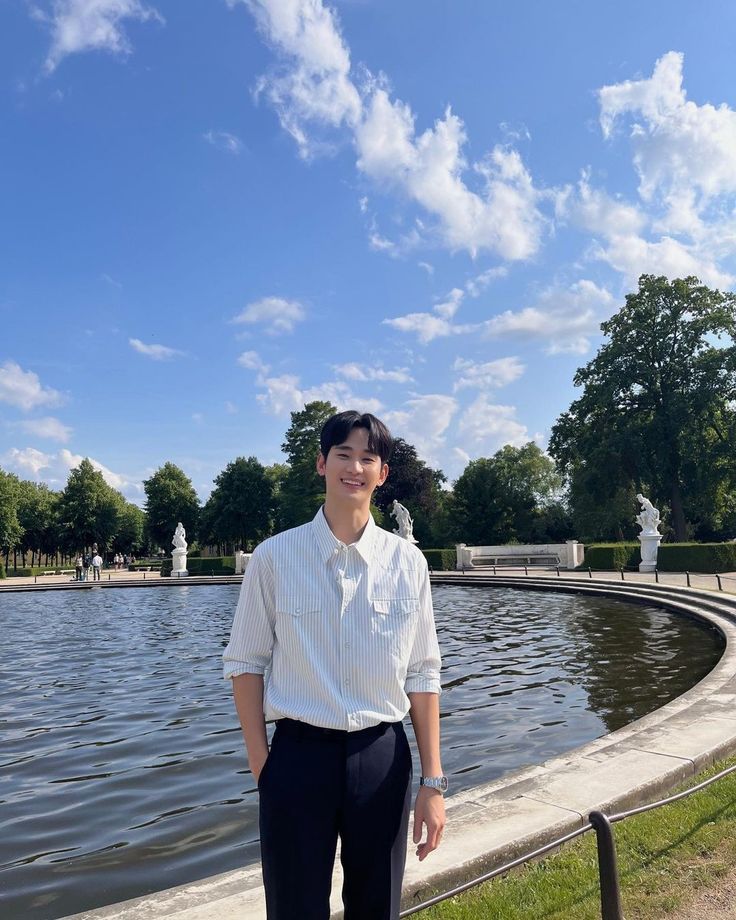 a man standing in front of a pond