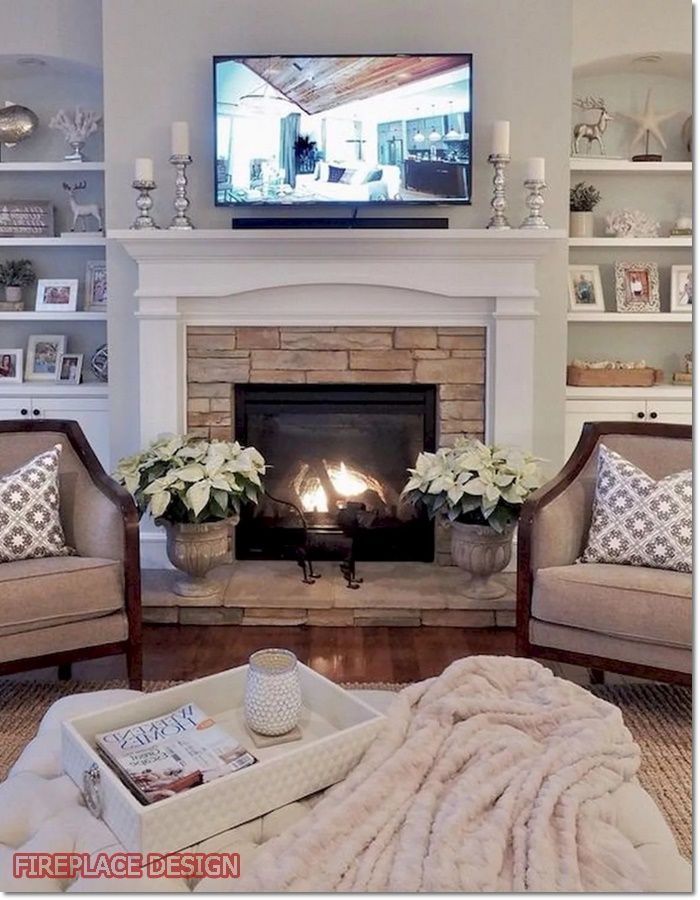 a living room with two couches and a fire place in front of the fireplace