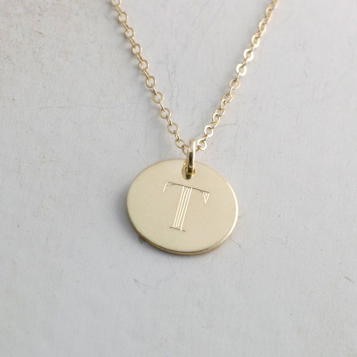 "Solid gold engraved initial necklace is a family heirloom that will be cherished and treasured for many years... it is the PERFECT gift! PICTURE IS ENLARGED TO SHOW DETAIL! SEE SECOND PICTURE FOR SIZE COMPARISON. PLEASE READ BELOW FOR ACTUAL MEASUREMENTS!! Your choice of one, two, or three solid gold 1/2\" (13mm) discs have been personalized just for you with a classy block font in a large 7mm size and it is GORGEOUS! (Font is shown in picture #6 above) The pendants hang from a solid 14k gold 1 Anniversary Jewelry With Initial Pendant Hallmarks, Anniversary Necklace With Initial Pendant And Hallmarks, Classic Necklaces With Initial Pendant For Anniversary, Classic Necklaces For Anniversary With Initial Pendant, Classic Engraved Initial Necklace As Gift, Classic Pendant Initial Necklace As A Gift, Classic Engraved Initial Necklace For Gift, Classic Charm Necklace For Anniversary, Classic Personalized White Gold Custom Necklace