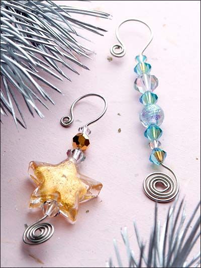 three different colored glass beaded earrings next to a silver christmas tree ornament