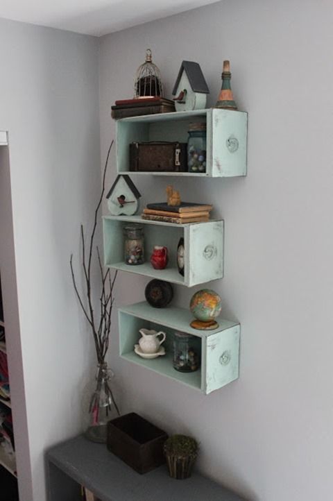 three shelves with various items on them in a room