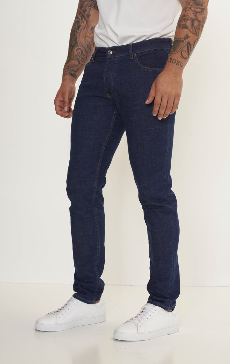 Fitted tapered jeans are a versatile and stylish choice for any wardrobe, offering a flattering silhouette and a modern look. These jeans are crafted from high-quality denim with a hint of stretch, ensuring both comfort and durability. The fitted style hugs the body in all the right places, accentuating curves while providing a sleek and streamlined appearance. The tapered leg adds a contemporary touch, narrowing towards the ankle for a flattering fit that pairs well with both sneakers and boots. Whether you're dressing for a casual day out or a night on the town, fitted tapered jeans can easily be dressed up or down. Pair them with a crisp button-down shirt and blazer for a polished look, or opt for a cozy sweater and sneakers for a more relaxed vibe. With their timeless appeal and versat Modern Tapered Straight Leg Jeans, Modern Denim Blue Jeans With Standard Cut, Modern Straight Fit Dark Wash Jeans, Slim Fit Jeans With Five Pockets For Everyday, Modern Dark Wash Straight Fit Jeans, Slim Jeans With Five Pockets For Everyday, Modern Dark Wash Denim Jeans, Modern Dark Wash Jeans, Modern Tapered Leg Jeans