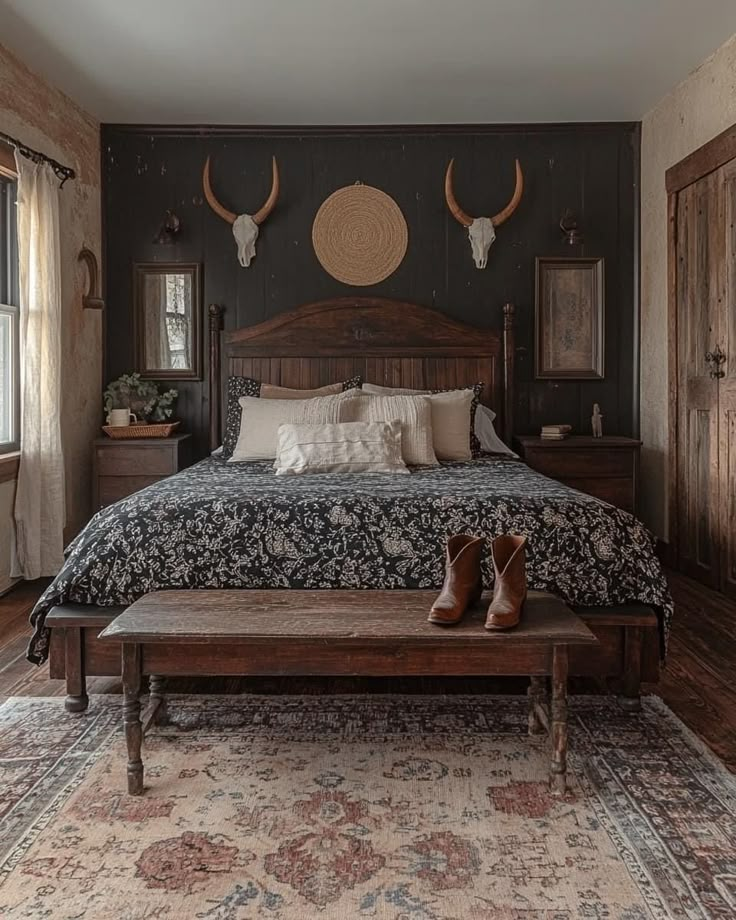 a bedroom with a large bed and two antlers on the wall