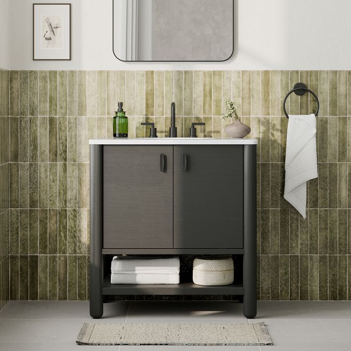 a bathroom with a sink, mirror and towel rack