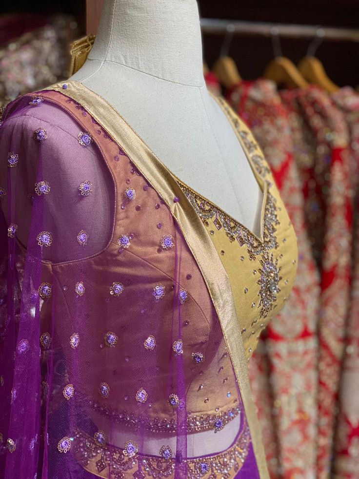 Violet purple skirt paired with contrasting golden zardozi and stone work blouse and net sequins butti dupatta. Fabric: Raw Silk This outfit can be customized in multiple colors and specific to client measurements. 90 days of production time is required and are for bulk orders only! Orders are processed in store only! Final fittings/alterations not included. Minimum Order Quantity- 4 pieces Gold Tissue Silk Party Wear Set, Gold Tissue Silk Choli With Gota Work, Purple Chanderi Lehenga For Reception, Silk Party Wear Choli With Sheer Dupatta, Gold Tissue Silk Traditional Party Wear, Purple Raw Silk Dupatta With Gota Work, Purple Silk Lehenga For Reception, Bollywood Dola Silk Dress In Gold, Gold Tissue Silk Set With Mirror Work