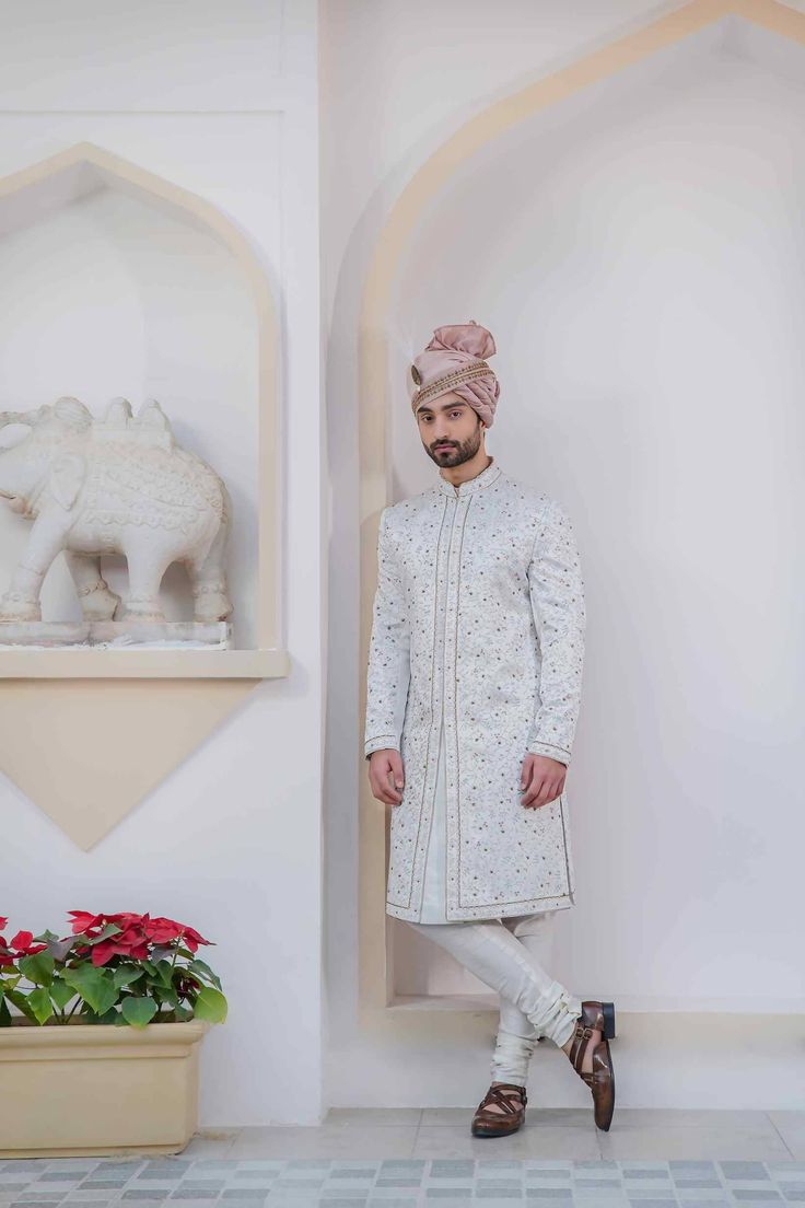 Featuring our new kashmiri jamawar embroidered sherwani set made with our staple three colors- champagne, ivory, and duckegg with hints of gold dabka. Completing the look with a double-bordered handmade safa, and a matching hand-embroidered stole, matching pintuck kurta and churidar. White Fitted Jamawar Bandhgala, White Jamawar Sherwani With Intricate Embroidery, Festive Cream Sherwani With Naqshi Detailing, Formal White Jamawar Traditional Wear, Festive Sherwani With Gold Embroidery For Traditional Ceremonies, White Bandhgala With Intricate Embroidery In Jamawar, White Jamawar Bandhgala With Intricate Embroidery, Fitted Cream Sherwani With Gold Embroidery, Cream Sherwani With Zari Work For Traditional Ceremonies