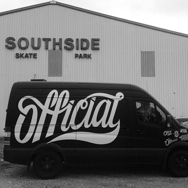 a black van parked in front of a building with the words southside skate park painted on it