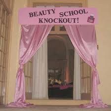 an entrance to a beauty school with pink drapes