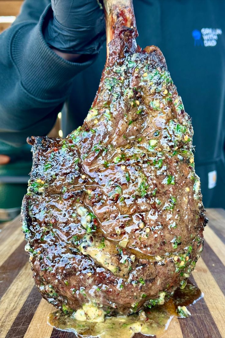 a large piece of meat sitting on top of a wooden cutting board