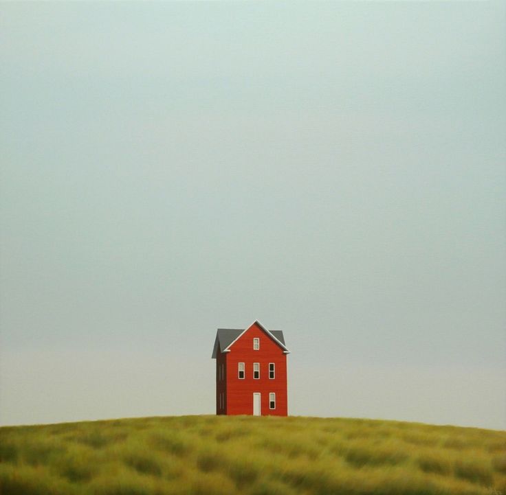 a red house sitting on top of a lush green field next to a tall grass covered hill