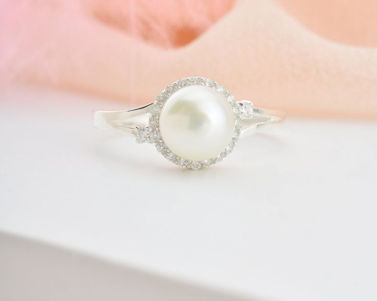 * Stunning handmade solid gold pearl ring. Adorned with tiny beads of white zircon gemstone to emphasize the unique design. This ring is designed to look elegant from all sides of your finger. You will not be able to take your eyes off the fascinating color of opal stone and the magnificent glitter of solid gold. 14K and 18K options are avaliable. It is suitable for daily use * ★Item Details ♥Made to Order ♥Gold Kt: 14K & 18K ♥Available Gold Color: Gold, Rose Gold, White Gold ♥Pearl Stone Si Pearl Ring With Diamond Accents, Elegant Pearl Ring With Birthstone, White Diamond Rings With Pearl Drop, Elegant Pearl Birthstone Ring, White Pearl Ring With Cubic Zirconia Center Stone, Wedding Pearl Drop Ring With Diamond, Pearl Gemstone Rings For Anniversary, Diamond Pearl Ring With Pearl Drop, Diamond Pearl Ring With Halo For Gift