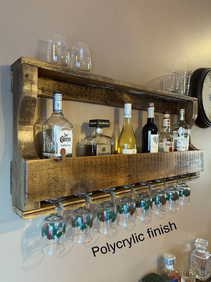 a wooden shelf filled with lots of bottles and glasses next to a wall mounted clock