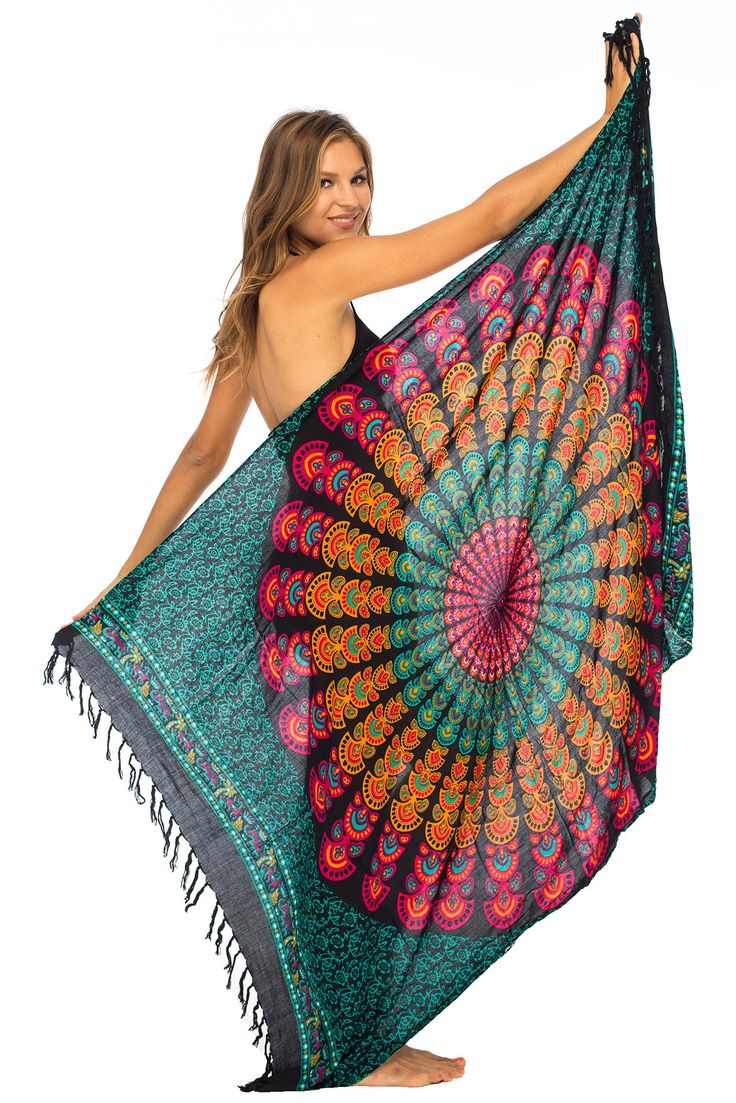 Brilliantly exotic, this sexy, lightweight beach sarong lures admiring eyes with its stunning peacock design. A mandala of painted feathers ripples out from the center, giving you every reason to strut your beauty by beach or poolside. Just cinch to fit with the coconut shell buckle to wear as a sarong dress, wrap skirt, bathing suit cover up or night-out shawl. Or use it to makes waves on the beach or at home as a lightweight blanket or tablecloth. Back From Bali is dedicated to creating beautiful, quality clothing with a heart. All of our items are crafted, sewn and painted by hand in Bali, by local artists and women who own small home businesses. For over 20 years, we have nurtured fair, honest and caring relationships with our artisans and their families – so you can feel as good about Multicolor Bohemian Sarong For Festivals, Bohemian Multicolor Sarong For Festivals, Red Bohemian Sarong For Festivals, Circular Mandala, Sarong Dress, Beach Sarong, Loungewear Dresses, Beach Attire, Peacock Print