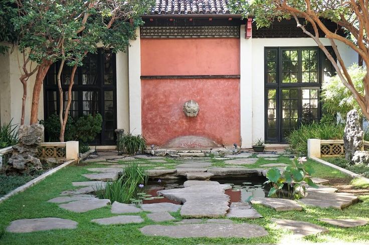 an outdoor courtyard with stepping stones and water features