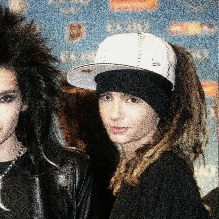 two young people with dread locks and baseball hats