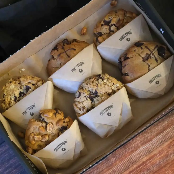 there are many muffins in the box on the table