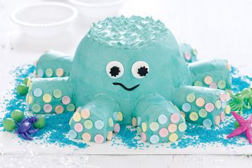 an octopus cake is decorated with blue icing and sprinkles on it