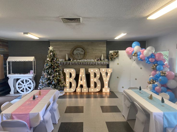 a baby shower is decorated with balloons and streamers in the shape of letters that spell out it's name