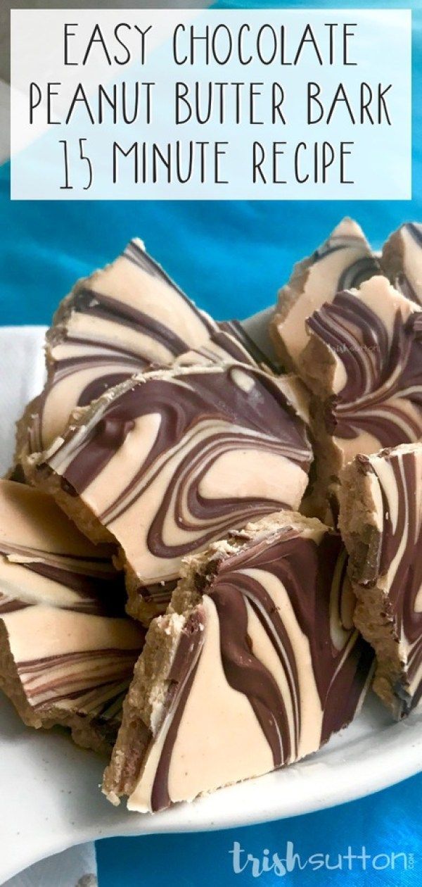 easy chocolate peanut butter bark recipe on a white plate with blue water in the background