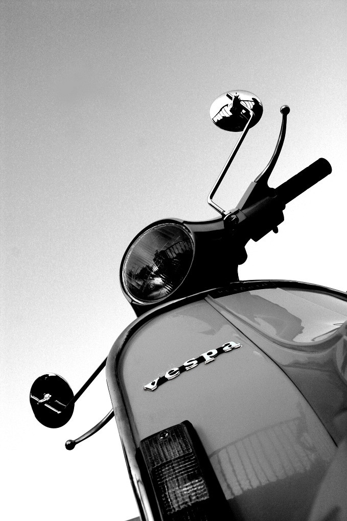 a black and white photo of a scooter with the license plate on it