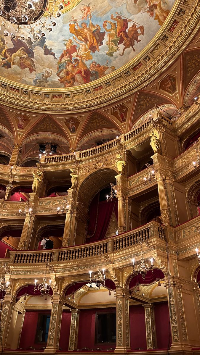 an ornately decorated auditorium with painted ceilings