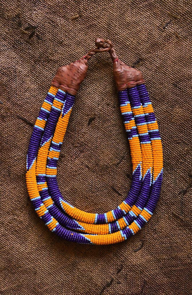 This Beaded Statement Collar is a classic and stylish African tribal necklace crafted using traditional tribal techniques. Featuring eco-friendly, colorful beads in a tribal pattern, this necklace is perfect for making a statement and will be a beautiful addition to any wardrobe. 9 inches Traditional Handmade Purple Beaded Necklaces, Traditional Purple Beaded Necklace With Round Beads, Statement Jewelry Necklace, Statement Collar, Beaded Jewlery, Beaded Collar, Necklace Craft, African Pattern, African Art