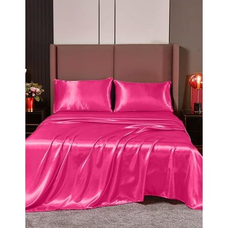 a bed covered in pink sheets and pillows