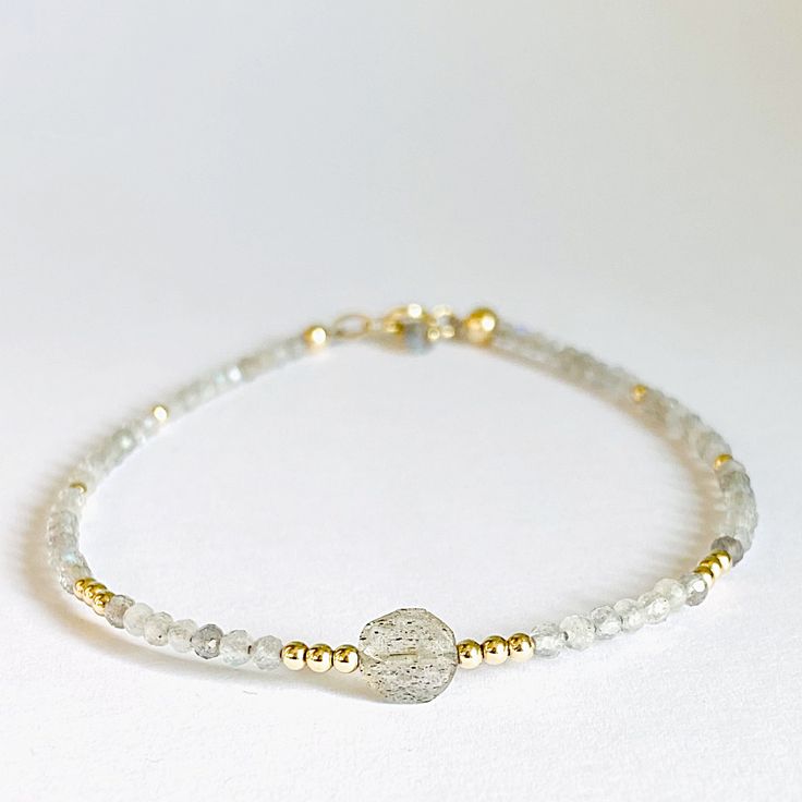 Tiny Moonstone Sparkle Bracelet Janine Gerade Gold Moonstone Beaded Bracelet As A Gift, Gold Moonstone Round Bracelets, Gold Moonstone Round Beads Jewelry, Gold Bracelets With Tiny Beads For Healing, Gold Moonstone Jewelry With Round Beads, Spiritual Gold Beaded Bracelets With Moonstone, Spiritual Gold Bracelets With Moonstone, Gold Beaded Labradorite Bracelets, Gold Beaded Labradorite Bracelet