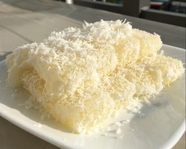 a white plate topped with cake covered in coconut