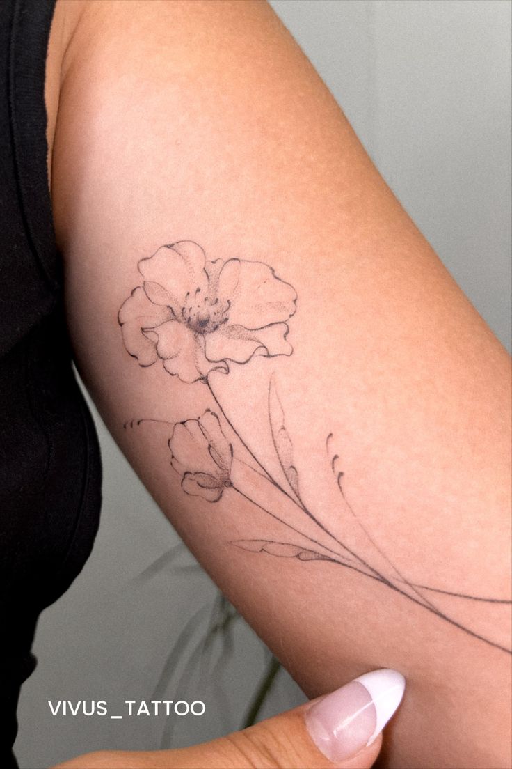 a woman's arm with a flower tattoo on the left side of her body