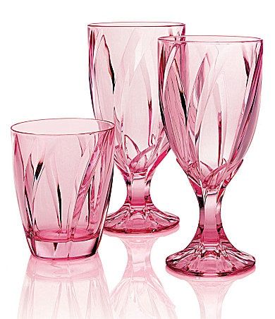 three pink glass goblets sitting next to each other