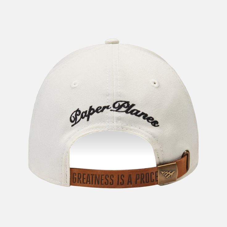 The Paper Planes Icon II Dad Hat is a simpler, relaxed baseball-style cap with unstructured panels, a lower profile, and a curved brim. This one-size-fits-all hat has an adjustable leather back strap with a metal logo buckle for a stylish everyday aesthetic. Features: 3-D embroidered Plane icon on front Paper Planes script embroidery on back Adjustable embossed “GREATNESS IS A PROCESS” leather strap with metal logo buckle “GREATNESS IS A PROCESS” interior taping 100% polyester twill Style: PP120 Classic Dad Hat For Baseball Season With Curved Bill, White Curved Bill Fitted Hat For Streetwear, White Fitted Hat With Curved Bill For Streetwear, Curved Bill Hats For Baseball Season Streetwear, Classic Dad Hat With Letter Print And Curved Visor, Urban Baseball Visor Hat, Urban Visor Hat For Baseball Season, Urban Style Baseball Season Visor Hat, Sports Fitted Hat With Curved Brim