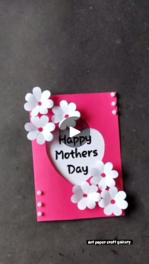 a mothers day card with white flowers and a heart cut out of paper on it