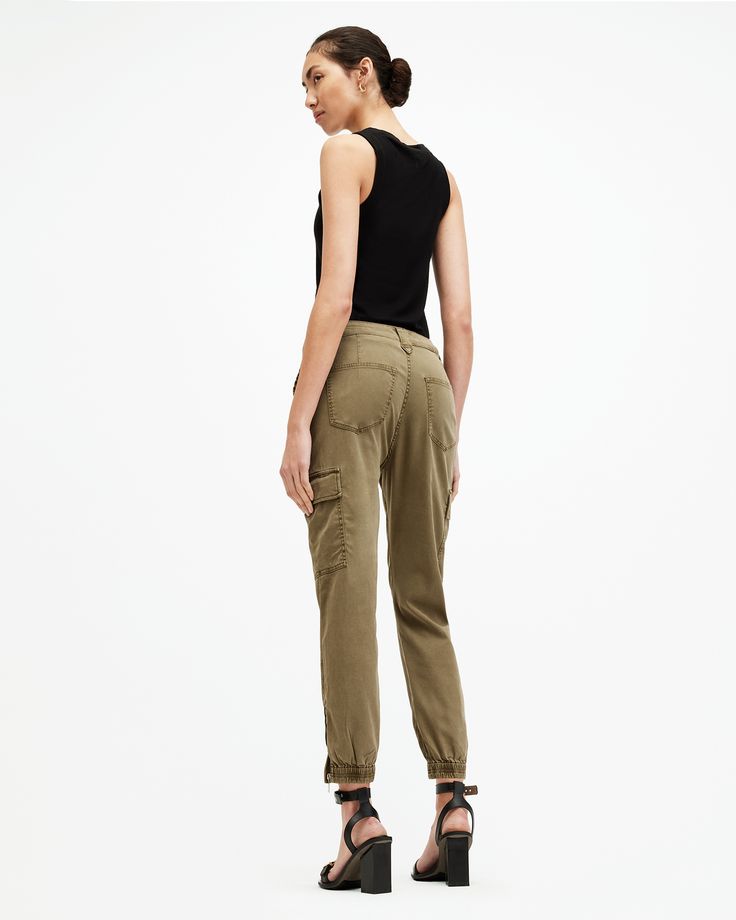 Swap your sweatpants out. Try the Nola Joggers. They're crafted from a stretch cotton-blend fabric that's super comfortable. Finished with classic cargo pocket detailing - pair them with a bodysuit for an easy look that goes from day to night.    These trousers are designed to a slim fit High-rise Zip closure Ankle length Cuffed ankles Stretch fabric Four cargo pockets Zip side seam at the ankle Allsaints Relaxed Fit Cotton Bottoms, Casual Spring Allsaints Bottoms, Relaxed Fit Straight Leg Cargo Joggers, Relaxed Fit Cargo Joggers With Straight Leg, Utility Cargo Style Sweatpants With Tapered Leg, Allsaints Relaxed Fit Straight Leg Bottoms, Allsaints Straight Leg Relaxed Fit Bottoms, Allsaints Straight Leg Bottoms Relaxed Fit, Allsaints Relaxed Fit Bottoms For Spring