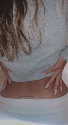 a woman with her hands on the back of her stomach