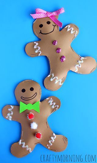 two gingerbreads made out of paper on a blue background