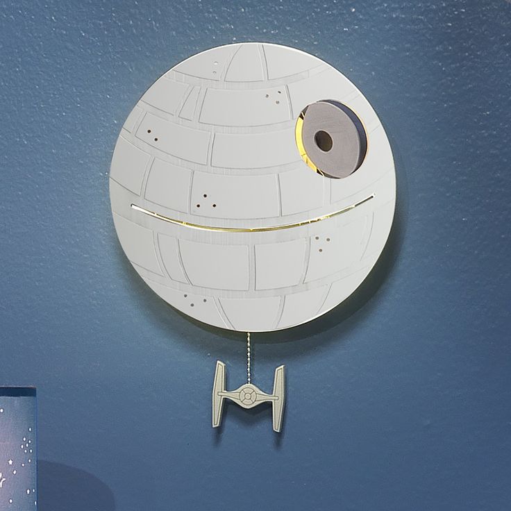 Every Star Wars fan is sure to love this light-up Death Star wall decor, as the Death Star is a cultural icon. It is back lit with an LED light which requires 3 AAA batteries, not included. There are multiple light emitting openings that add interest and dimension to this amazing light up wall decor. At the bottom a Tie Fighter hangs from a metal chain to power this space station on or off. This is an awesome gift to welcome home your little padawan (Jedi in training) and is a top baby registry pick as well. Star Wars Baby Room, Star Wars Kids Room, Star Wall Decor, Star Wars Baby Shower, Star Wars Bedroom, Star Wars Nursery, Mommy Shark, Star Wars Light, Star Wars Room