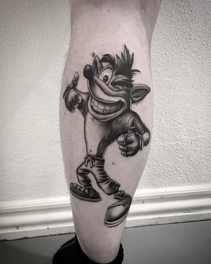 a black and white tattoo design of a cartoon character on the calf's leg