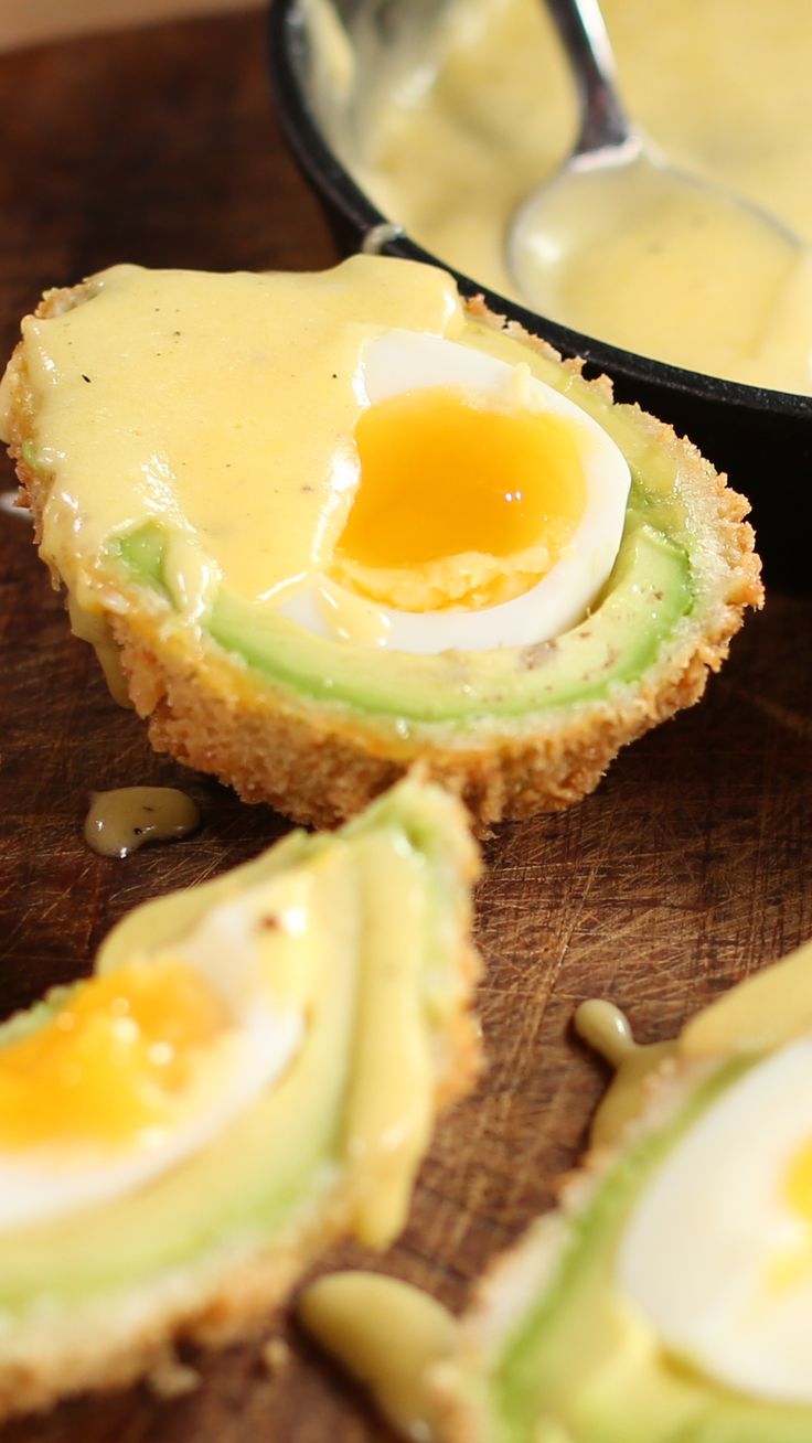 an avocado and egg muffins are on a cutting board with a spoon