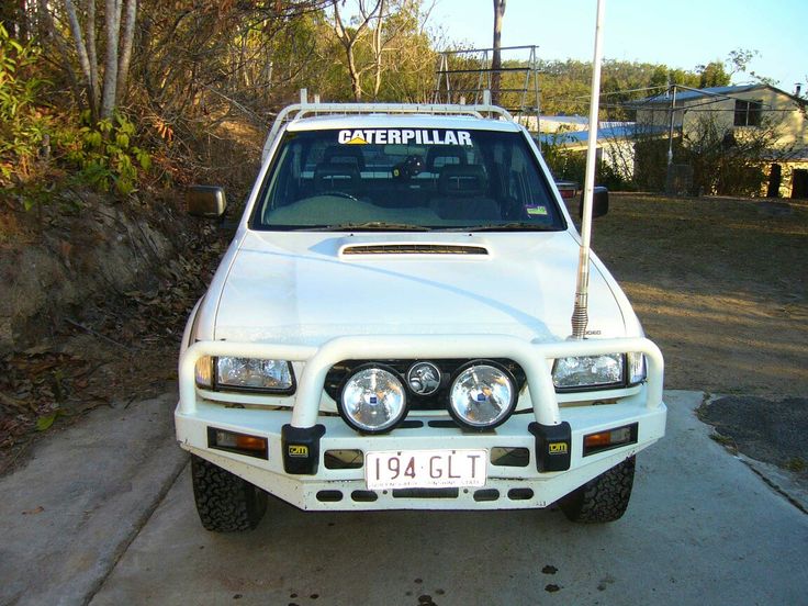 a white truck parked on the side of a road