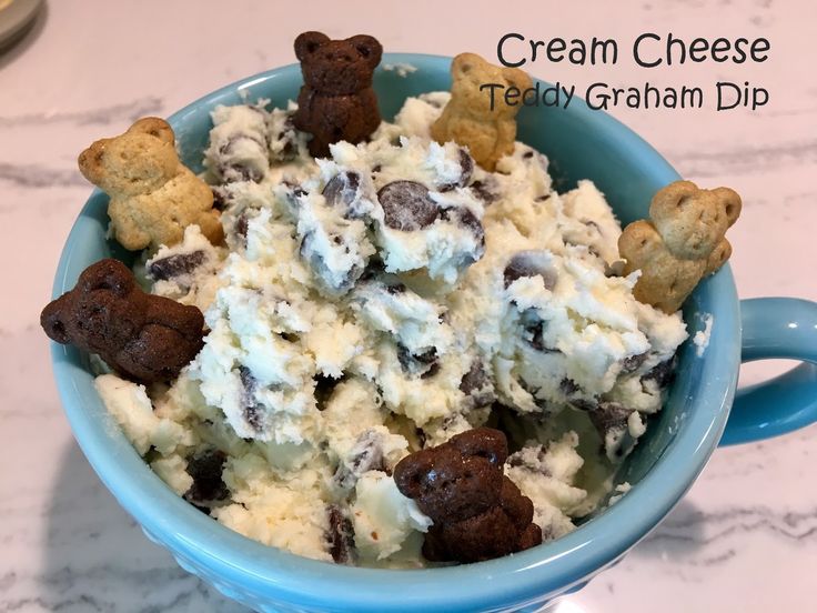 a blue bowl filled with ice cream and cookies