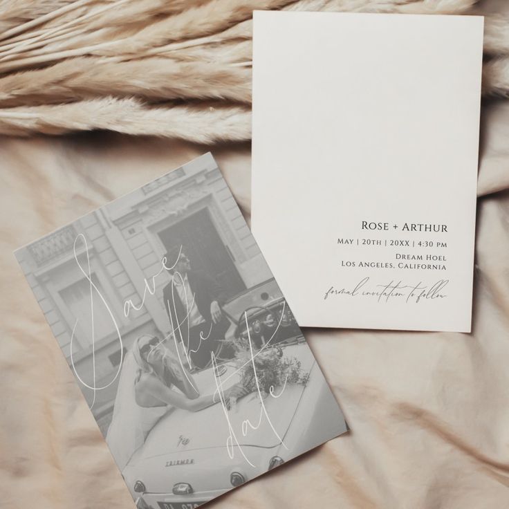 an old photo is laying on a bed next to a wedding program and postcard