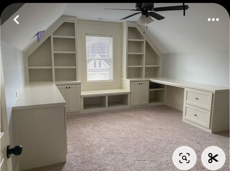 an empty room with built - in shelves and cabinets, carpeted flooring and ceiling fan