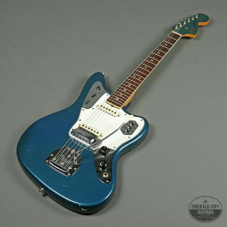 a blue electric guitar sitting on top of a table