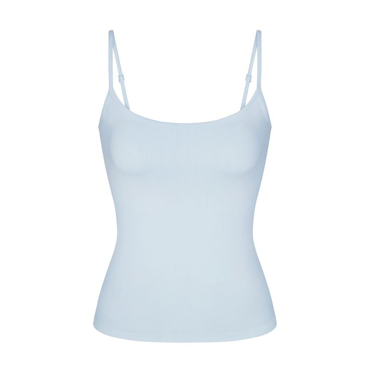 Getting dressed is smoother in SKIMS. Made with our buttery-sleek fabric that smooths and hugs your body, this lightly supportive tank flatters your figure and levels up your off-duty comfort. Features a shelf bra with underbust elastic for light bust support, a scoop neck, and adjustable straps. Hits below the natural waist. Fits true to size. Viral Clothes 2024, Cute Clothing Pieces, Cute Blue Tops, Light Blue Spaghetti Strap Top, Fitted Light Blue Cami Top, Fitted Light Blue Camisole, Stockholm Clothes, Kyanite Skims, Blue Seamless Camisole