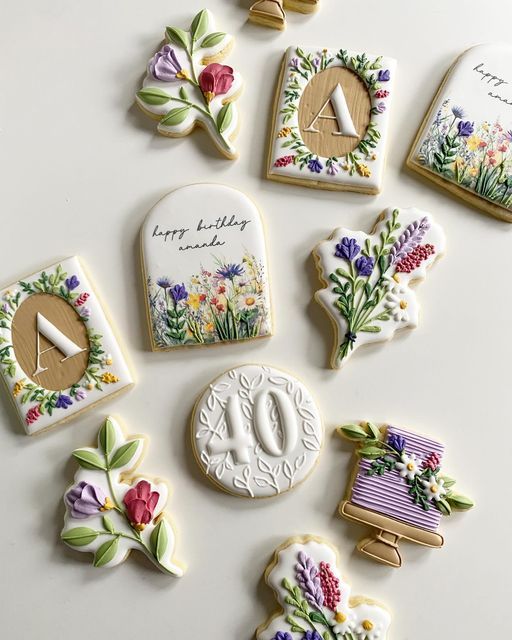 decorated cookies are arranged in the shape of letters and numbers, with flowers on them