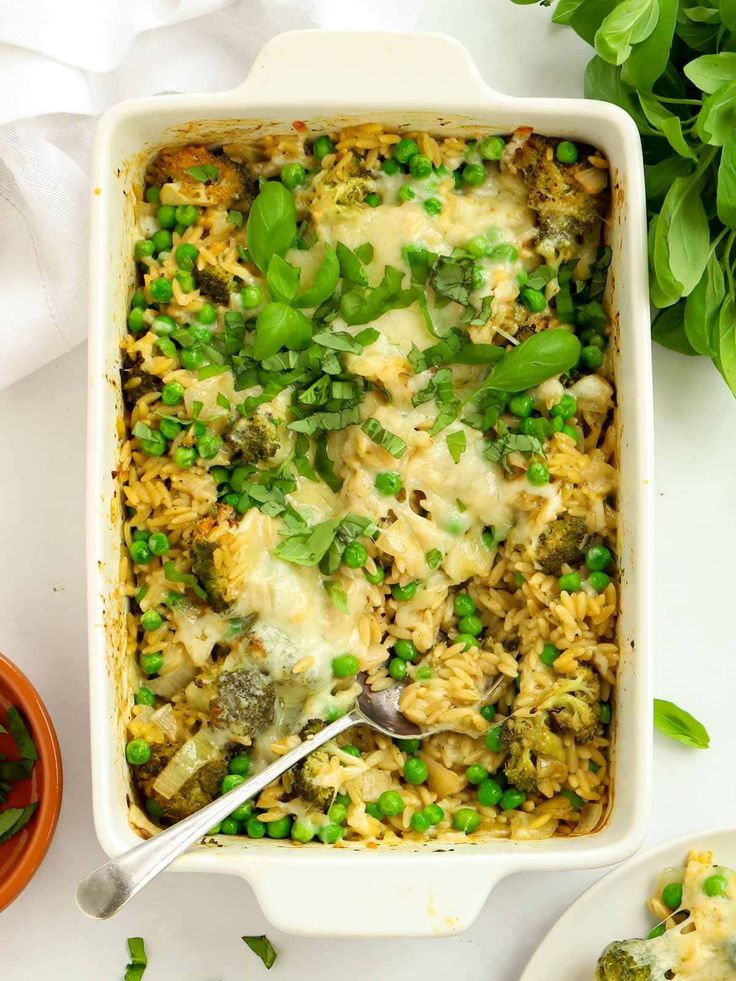 a casserole dish filled with peas and rice